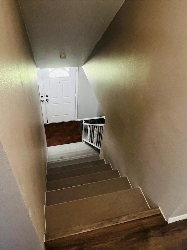 staircase featuring wood finished floors