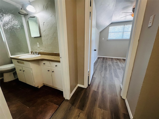 bathroom featuring vanity, a ceiling fan, wood finished floors, and vaulted ceiling