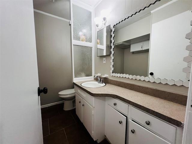 bathroom featuring toilet, tile patterned floors, and vanity