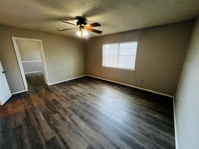 interior space with baseboards, ceiling fan, a textured ceiling, and dark wood-type flooring