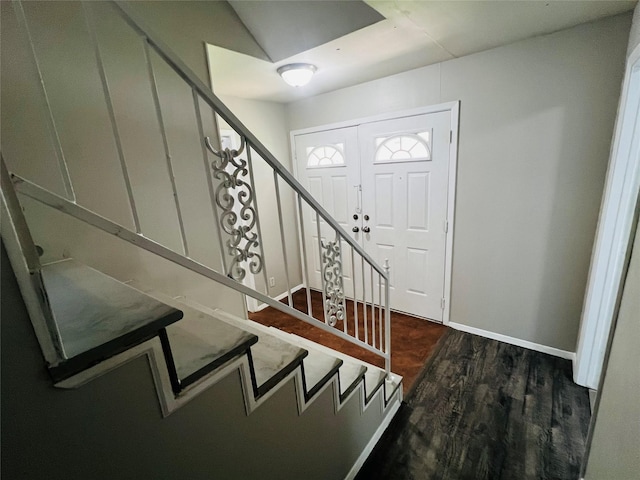 entrance foyer featuring baseboards, stairs, and wood finished floors