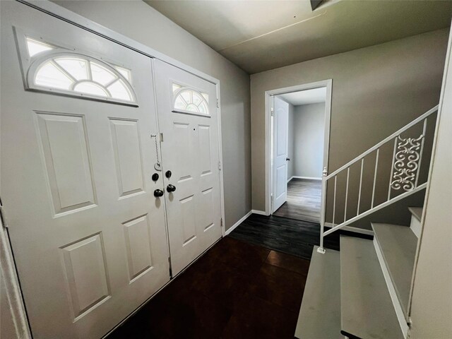 entrance foyer with stairs and baseboards