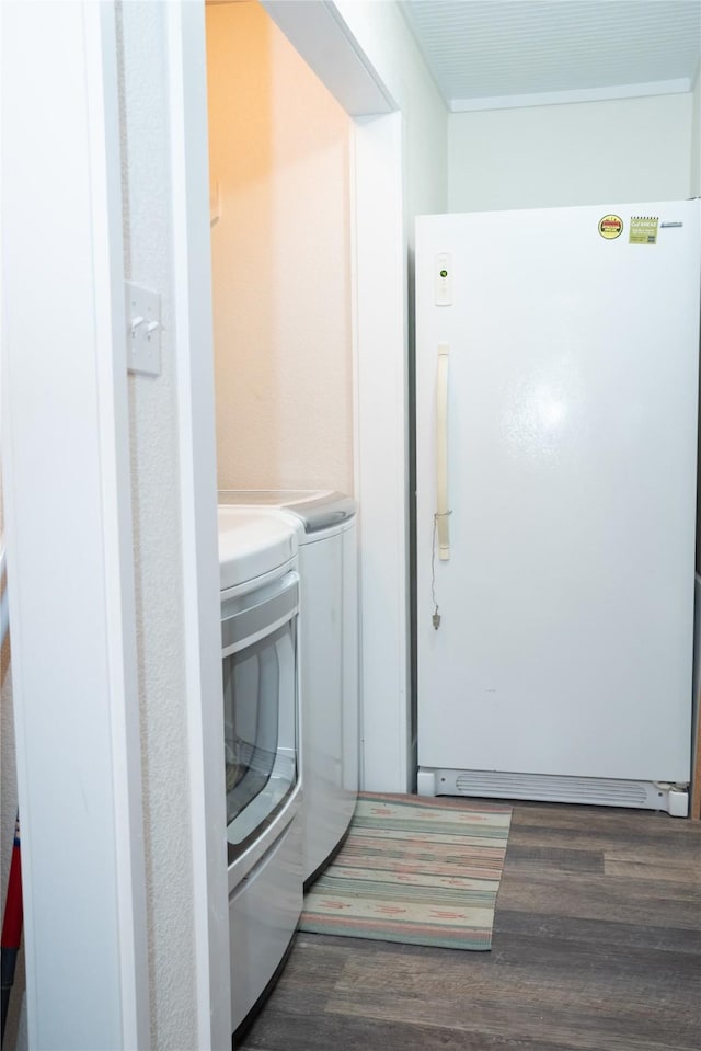 1980 SE County Road 3310th Rd, Kerens, TX 75144 - washroom with dark wood-type flooring, laundry area, and washing machine and clothes dryer