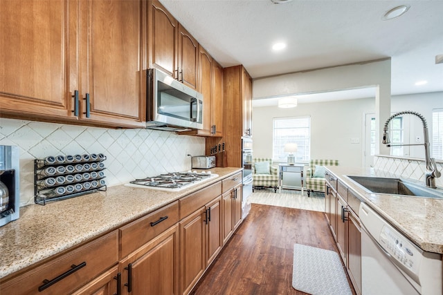 1200 Ridgeway Dr, Richardson, TX 75080 - kitchen featuring a sink, dark wood finished floors, appliances with stainless steel finishes, and brown cabinets