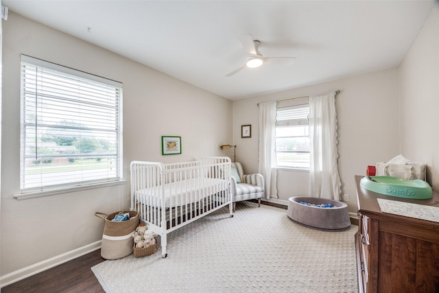 1200 Ridgeway Dr, Richardson, TX 75080 - bedroom featuring baseboards, a ceiling fan, a crib, and wood finished floors