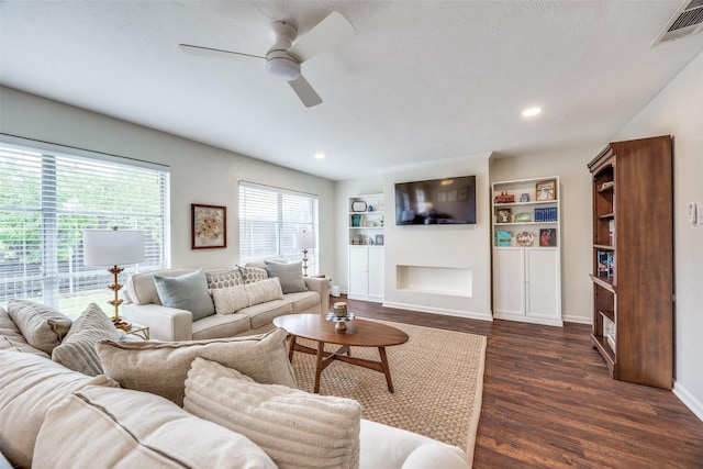 1200 Ridgeway Dr, Richardson, TX 75080 - living area with dark wood-style flooring, built in shelves, a ceiling fan, baseboards, and visible vents