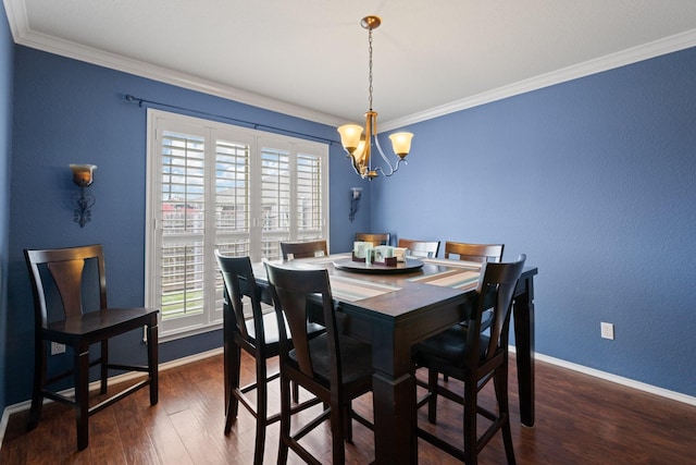 dining space featuring crown molding, dark wood-style flooring, baseboards, and a notable chandelier