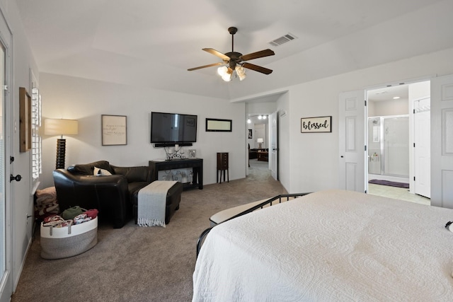 bedroom with ensuite bathroom, carpet flooring, and visible vents