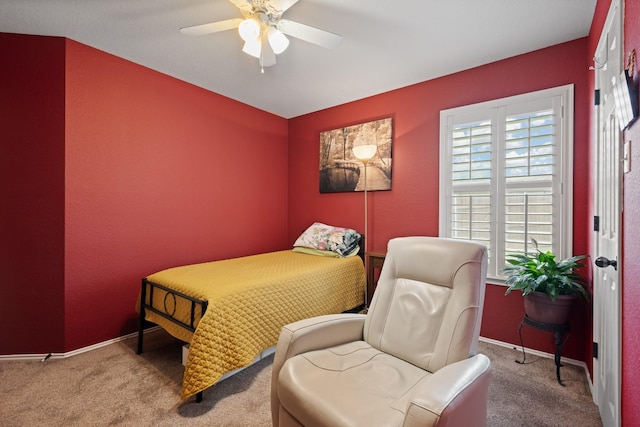 carpeted bedroom featuring a ceiling fan and baseboards