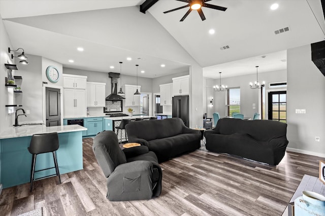 living room featuring visible vents, beam ceiling, high vaulted ceiling, dark wood finished floors, and ceiling fan with notable chandelier