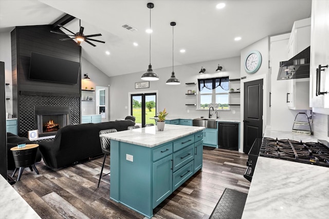 kitchen with dark wood-style flooring, open floor plan, high vaulted ceiling, blue cabinets, and black appliances