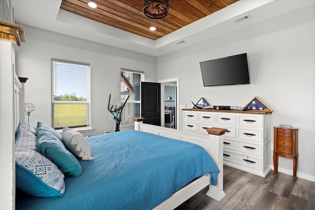 bedroom featuring a raised ceiling, baseboards, dark wood-type flooring, visible vents, and wood ceiling