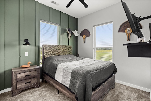 carpeted bedroom featuring a ceiling fan, baseboards, and visible vents
