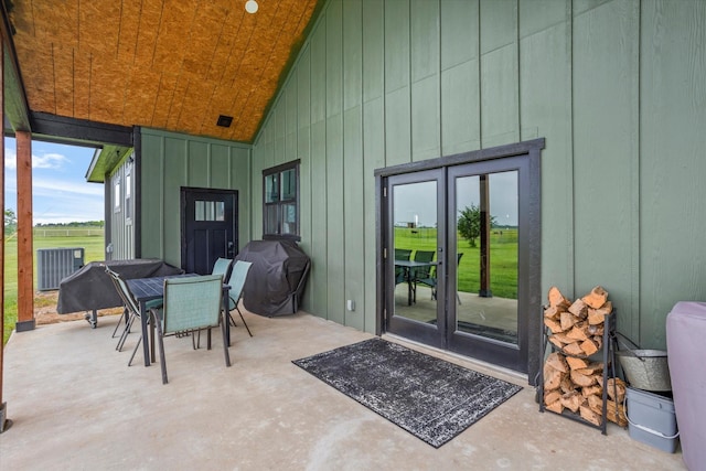 view of patio with area for grilling, central AC unit, outdoor dining area, and french doors
