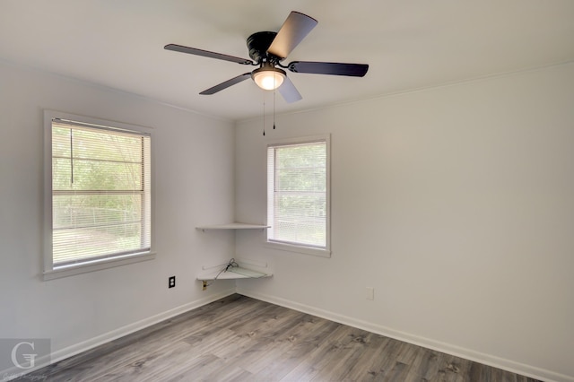unfurnished room with baseboards, a ceiling fan, and wood finished floors