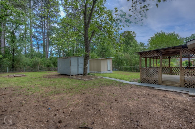 view of yard featuring an outdoor structure, a fenced backyard, and a shed