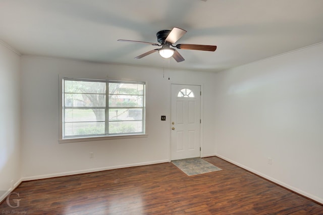 foyer entrance with crown molding, baseboards, a ceiling fan, and wood finished floors
