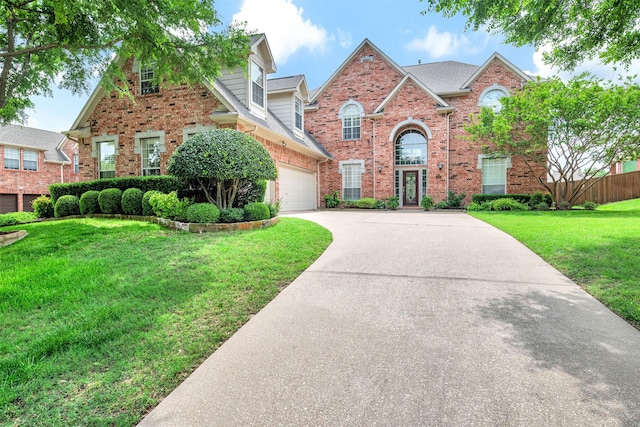 3906 Sharp Ln, Richardson, TX 75082 - traditional home featuring concrete driveway, a front lawn, and brick siding