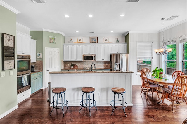 3906 Sharp Ln, Richardson, TX 75082 - kitchen with appliances with stainless steel finishes, ornamental molding, and white cabinetry