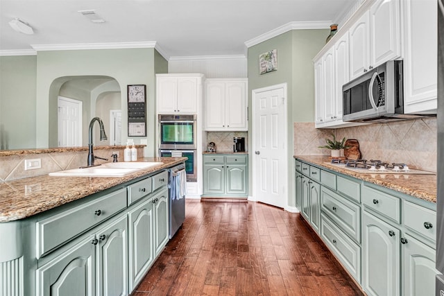 3906 Sharp Ln, Richardson, TX 75082 - kitchen featuring a sink, stainless steel appliances, dark wood-style floors, and white cabinetry