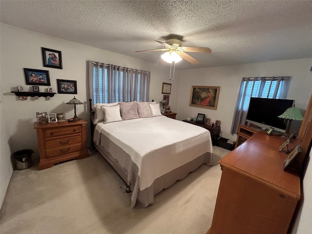 222 County Road 3331, Paradise, TX 76073 - bedroom with light carpet, a ceiling fan, and a textured ceiling