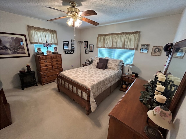 222 County Road 3331, Paradise, TX 76073 - bedroom with a textured ceiling, ceiling fan, light colored carpet, and a wood stove