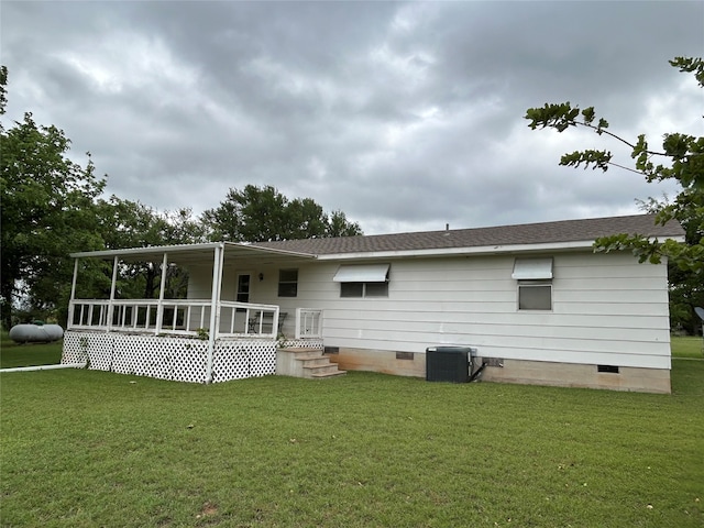 222 County Road 3331, Paradise, TX 76073 - back of property featuring a lawn, crawl space, central AC unit, and a shingled roof