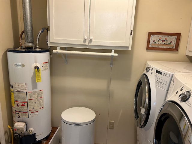 222 County Road 3331, Paradise, TX 76073 - clothes washing area with cabinet space, separate washer and dryer, and gas water heater