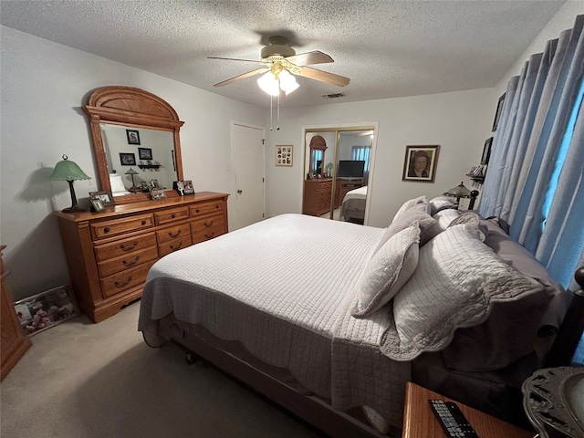 222 County Road 3331, Paradise, TX 76073 - bedroom with a ceiling fan, a textured ceiling, visible vents, light colored carpet, and a closet