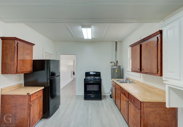 kitchen featuring brown cabinets, light wood-type flooring, light countertops, a sink, and black appliances