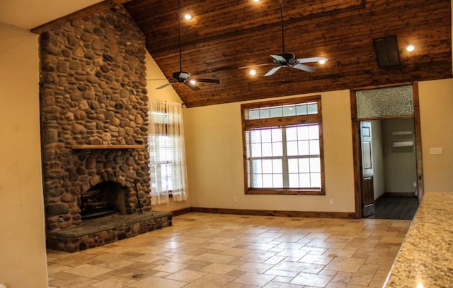 unfurnished living room with a ceiling fan, a stone fireplace, wooden ceiling, baseboards, and high vaulted ceiling