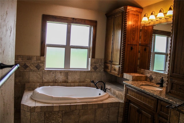 bathroom with vanity and a garden tub