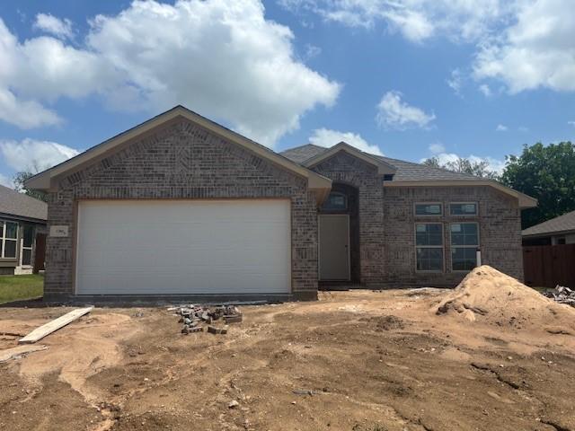 ranch-style house with brick siding and a garage