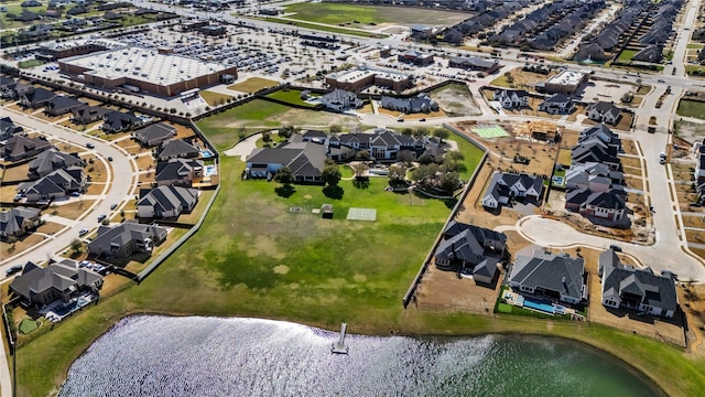 birds eye view of property with a water view and a residential view