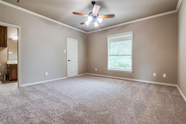 spare room featuring baseboards, ceiling fan, ornamental molding, and light colored carpet