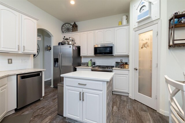 kitchen with appliances with stainless steel finishes, backsplash, and white cabinetry