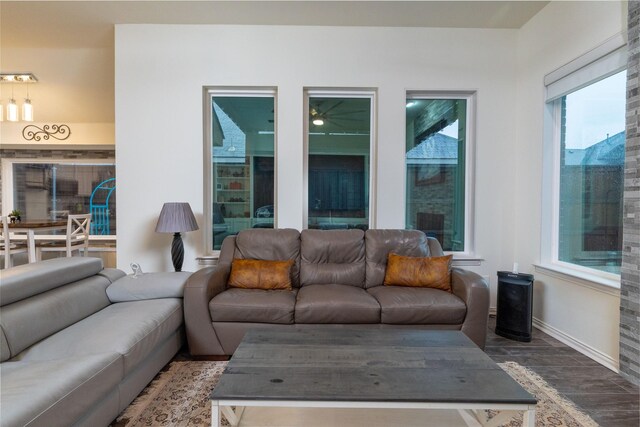 living room with baseboards and wood finished floors