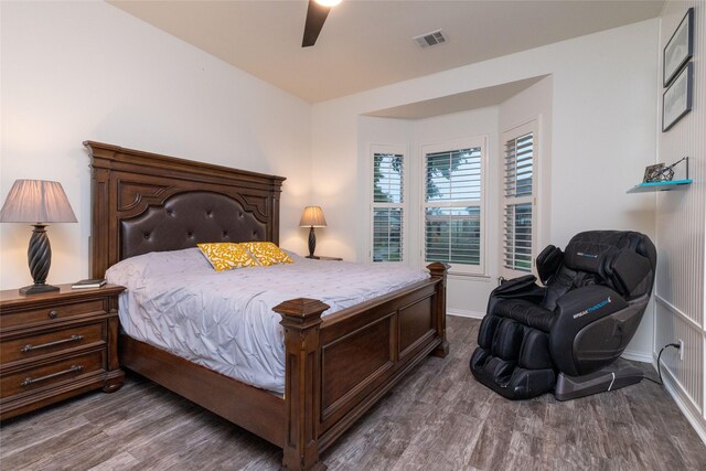 bedroom with visible vents, baseboards, ceiling fan, and wood finished floors