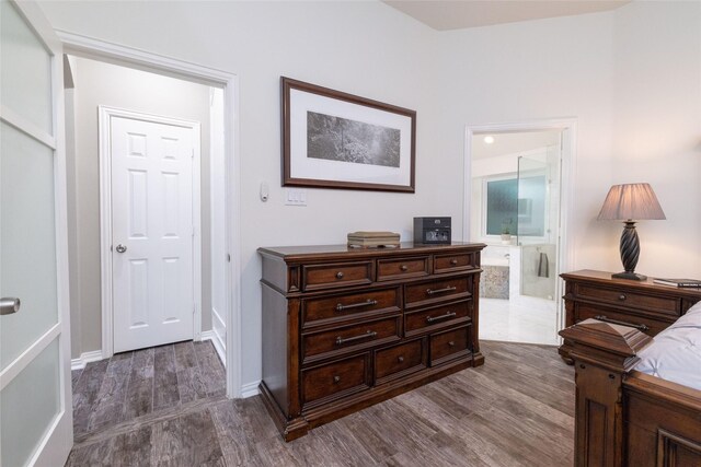 hallway featuring baseboards and dark wood-style flooring