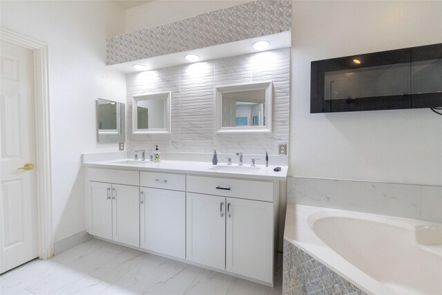 full bath with double vanity, a sink, marble finish floor, and a bath