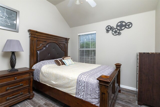 bedroom with baseboards, wood tiled floor, ceiling fan, and vaulted ceiling