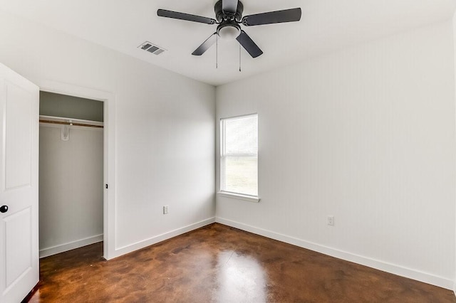 unfurnished bedroom featuring visible vents, a closet, baseboards, a ceiling fan, and concrete floors