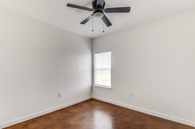 unfurnished room featuring baseboards, concrete floors, and ceiling fan
