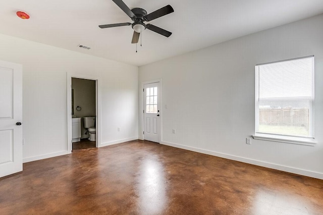 empty room featuring finished concrete floors, a ceiling fan, baseboards, and visible vents