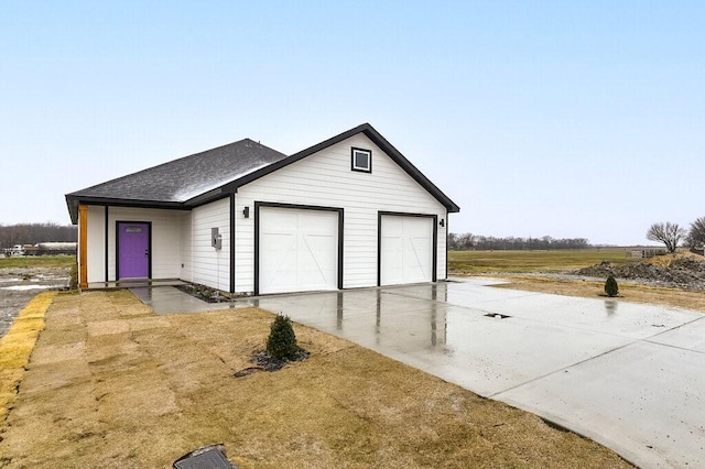 garage with concrete driveway