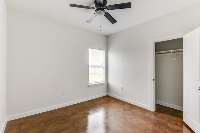 unfurnished bedroom with baseboards, a ceiling fan, a closet, and concrete floors