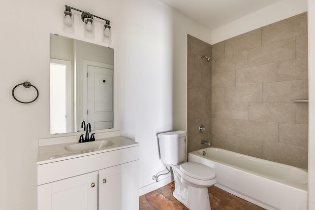 full bath featuring vanity, bathtub / shower combination, toilet, and wood finished floors