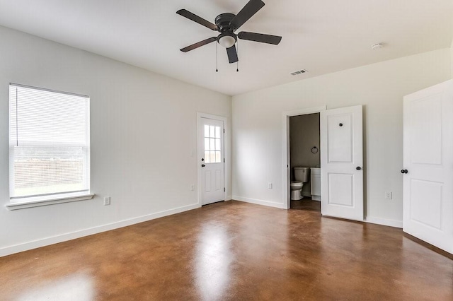 empty room featuring baseboards, ceiling fan, concrete flooring, and visible vents