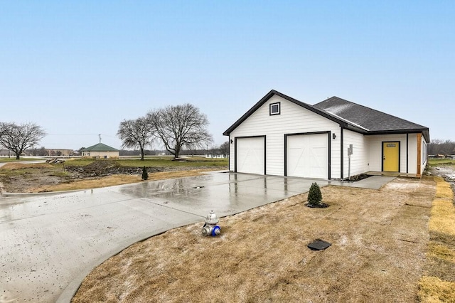 garage with concrete driveway