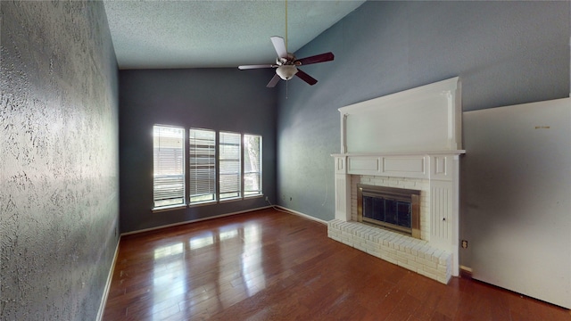 unfurnished living room featuring a brick fireplace, high vaulted ceiling, a ceiling fan, baseboards, and wood finished floors